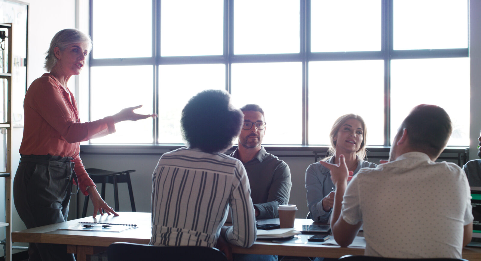 Teacher leading a small group of colleagues at a work table
