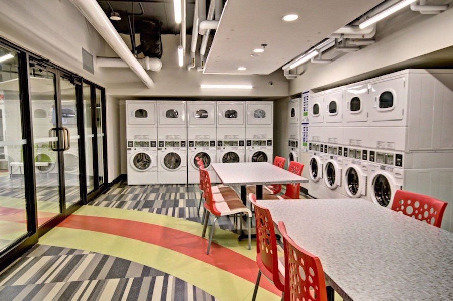 Laundry room with washers and dryers at the evo residence
