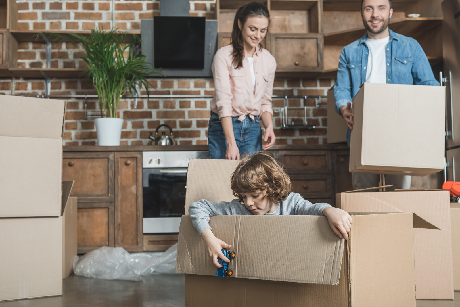 Family unpacking boxes in their new home in Canada